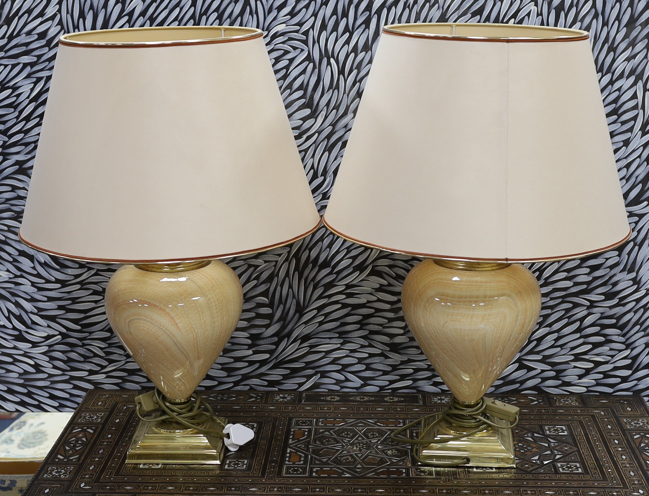 A pair of marbled ceramic and brass designer table lamps,, 61 cms including shades.